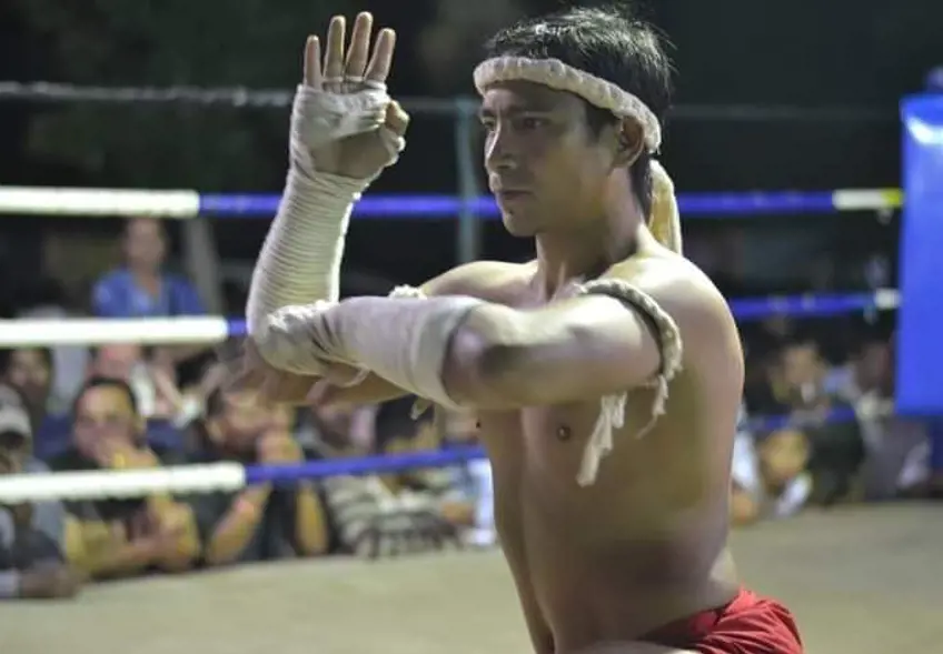 Trainer Kru Padu performing the Wai Kru Ram Muay