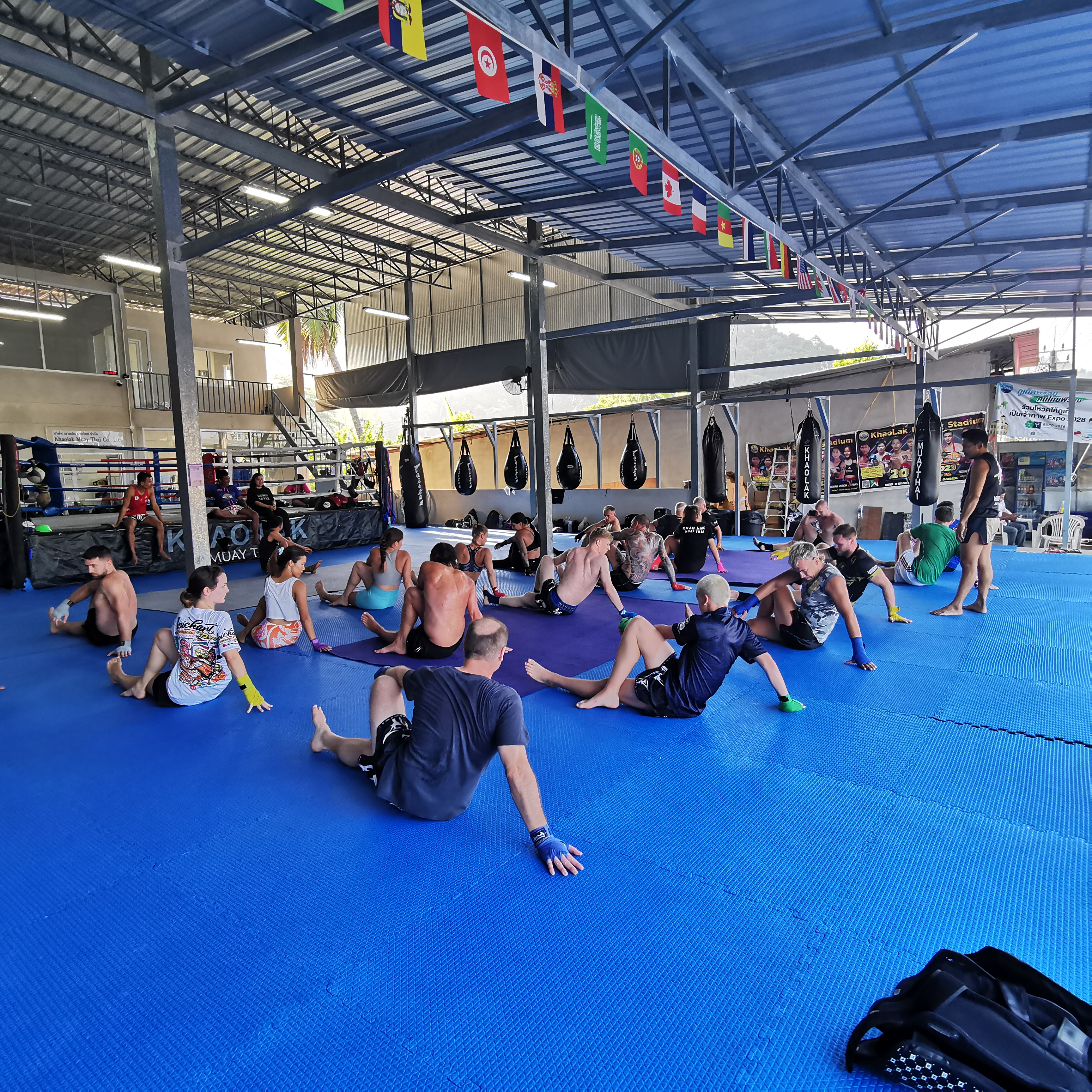 Photo of large group doing pre-training warm-up and stretch